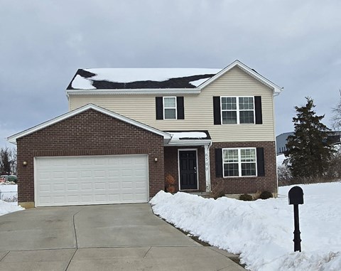 A house with a garage and a mailbox in front.